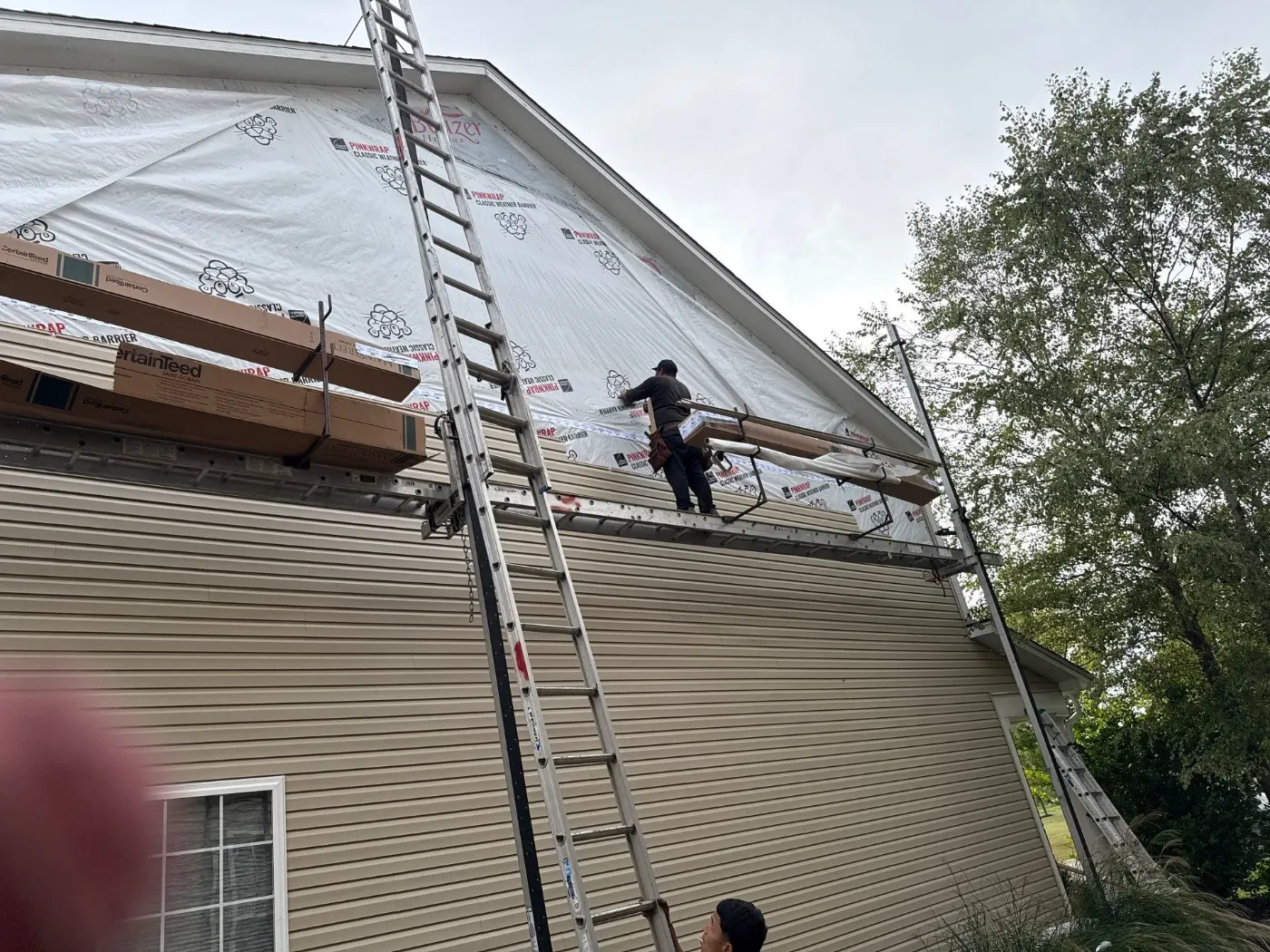 Tarping and dry-in on a Village of West Clay commercial roof